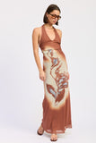 Woman wearing a brown maxi dress with a floral pattern on a white background